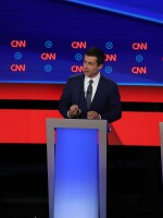 Democratic presidential candidate South Bend, Ind., Mayor Pete Buttigieg (center), speaks while Sens. Amy Klobuchar and Bernie Sanders listen during the Democratic presidential debate in Detroit on Tuesday. All three agree on the need to ban assault-style weapons and for a universal background check for gun buyers.