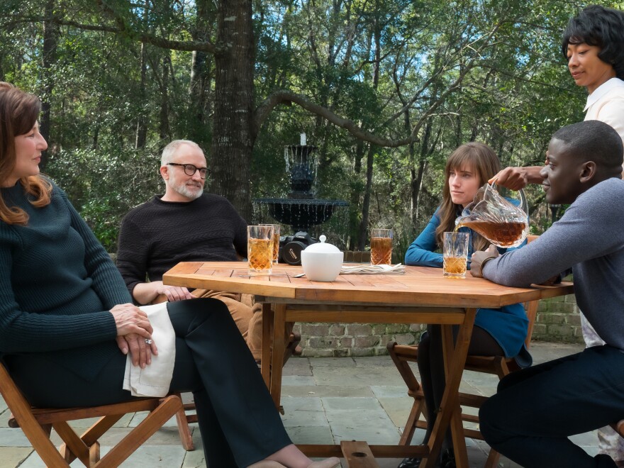 From left to right: Missy (Catherine Keener), Dean (Bradley Whitford), Rose (Allison Williams), Georgina (Betty Gabriel) and Chris (Daniel Kaluuya) in Universal Pictures' <em>Get Out</em>, a speculative thriller written, produced and directed by Jordan Peele.