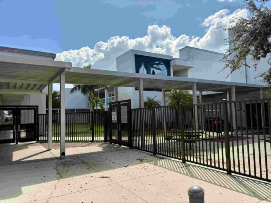 A gate and school building.