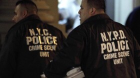 Crime scene unit officers outside the Manhattan apartment building where the children were killed Thursday.