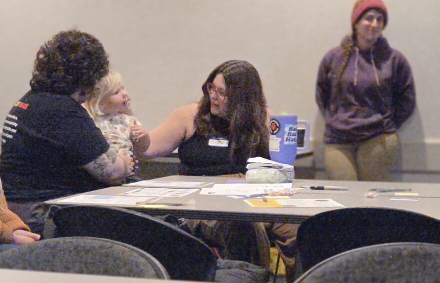 Crystal Noble greets her 2-year-old daughter Ruby after speaking during the Bemidji Affordability Forum on Dec. 3, 2025.