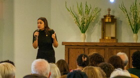 Rep. Alexandria Ocasio-Cortez speaks to a crowd at All Saints Catholic Church.