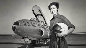 An undated photograph shows Wally Funk standing with a U.S. Air Force jet.