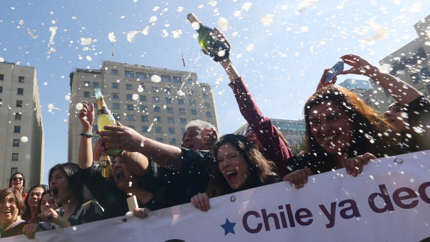 Activists celebrate outside the Constitutional Court in Santiago, Chile, on Monday. The court approved a measure to ease the country's strict abortion ban by decriminalizing the procedure in certain cases.