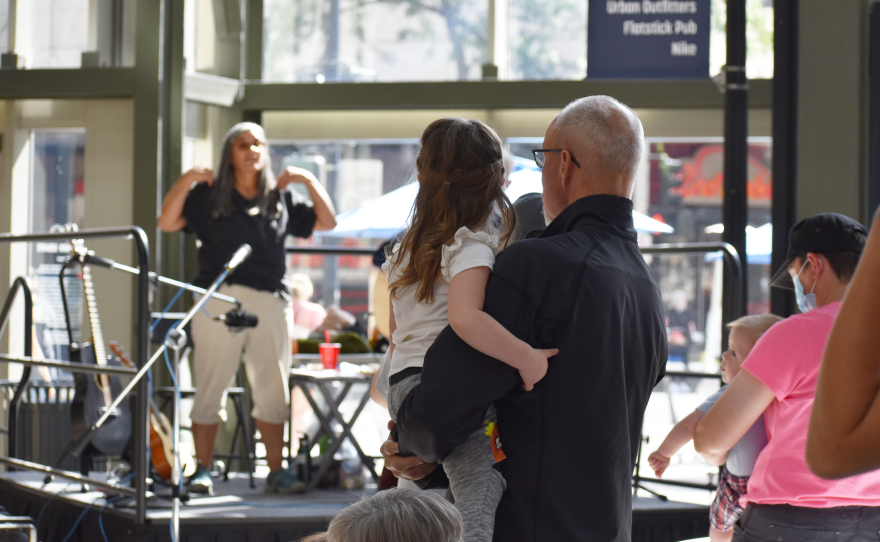 A child and adult dance at the concert
