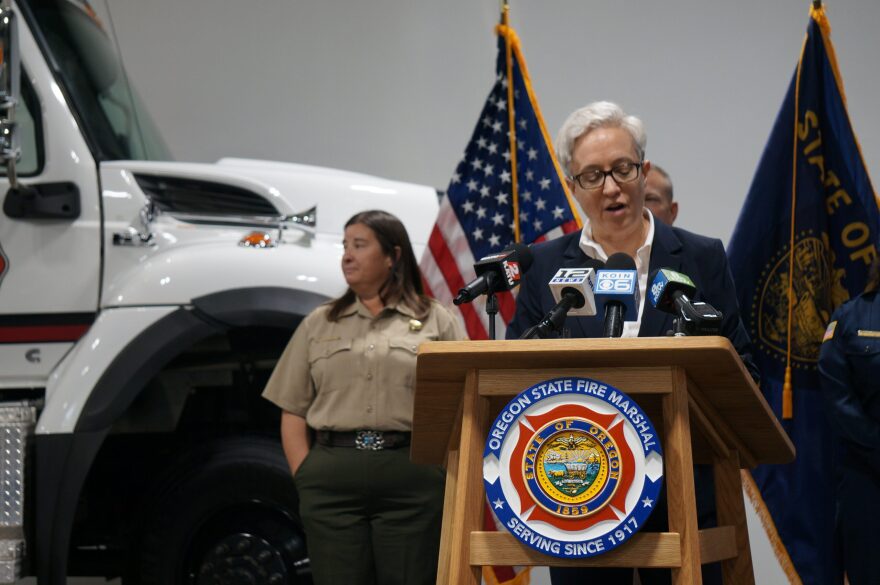 Gov. Tina Kotek (center) and Kacey KC, the new director of the Oregon Department of Forestry (left), at a briefing on the wildfire season at the Office of the State Fire Marshal in Salem on May 5, 2026.