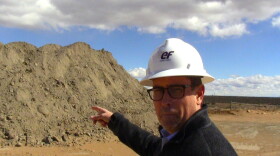 Curtis Moore, Vice President of Marketing at Energy Fuels Inc., with a uranium ore pile at the Energy Fuels uranium mill in southeast Utah.
