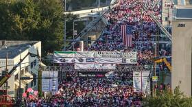 Participants in the Race for the Cure running across the Broadway Bridge in downtown Little Rock.