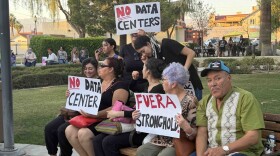 Maria Duarte, center right holding a “Fuera Stronghold” sign, said she has lived in the Coachella Valley since the 1970s and worries data centers could bring more costs than benefits for local residents.