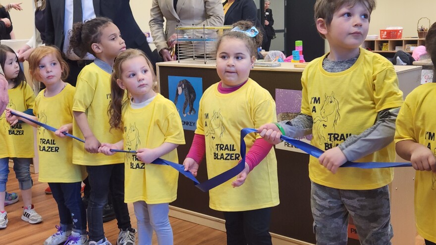 Children hold the ribbon for the official opening of the Marcella Nagorski-Waldow Center for Innovative Teaching and Learning at Luzerne County Community College on Friday.