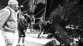 The Wu Tang Clan sprays champaign from the stage onto the crowd