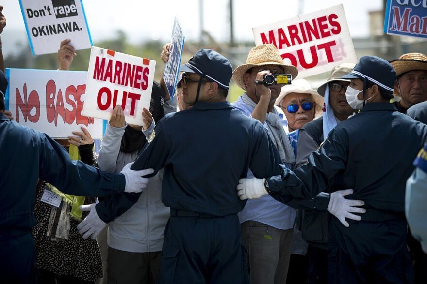 Police officers block the road as people stage a rally against the U.S. military presence on Okinawa.