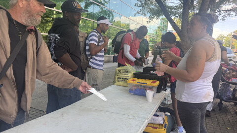 People line up for meals and beverages outside Richland Library Main in Columbia.