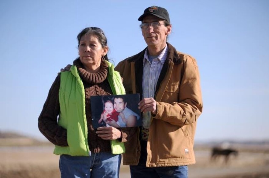 Cletus and Earline Cole hold a picture of their son Steven Bearcrane-Cole with his daughter, Precious. The Cole family has been involved in a decade-long lawsuit against the FBI for what they alledge was a mishandling of their son's death in 2005.