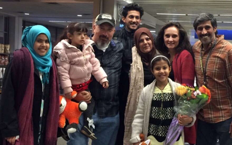 Paul Braun and Philip with their families at Minneapolis-St. Paul International Airport the day Philip's family arrived.