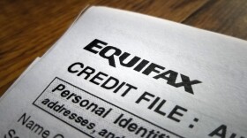 Close-up of the upper corner of a consumer credit report from the credit bureau Equifax, with text reading Credit File and Personal Identification, on a light wooden surface, September 11, 2017. In September of 2017, a data breach at Equifax exposed the personal information of thousands of customers. (Photo via Smith Collection/Gado/Getty Images).