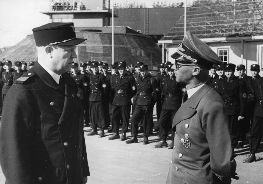 Vidkun Quisling (left) in front of an honorary partnership of the paramilitary Hirden during the Nazi occupation of Norway.