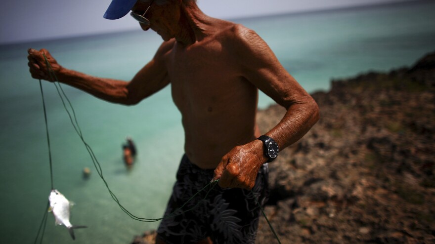 Retired teacher Manuel Landin Rodriguez fishes just off the 18th hole of a golf course in Varadero. He remembers the days before the Cuban Revolution — but does not yearn for them.