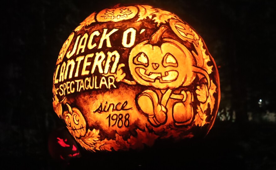 A pumpkin with the Jack O'Lantern Spectacular's logo etched on the front