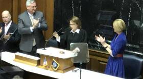 Gov. Eric Holcomb (left) and Lt. Gov. Suzanne Crouch (right) applaud Chief Justice Loretta Rush as she completes her State of the Judiciary address.