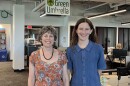 Two people stand in an office under a sign that says Green Umbrella.