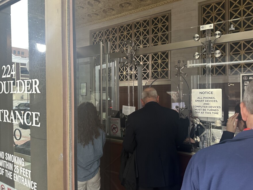Court attendees line up to go through security before a Mar. 6 hearing in Frizzell's Tulsa courtroom.