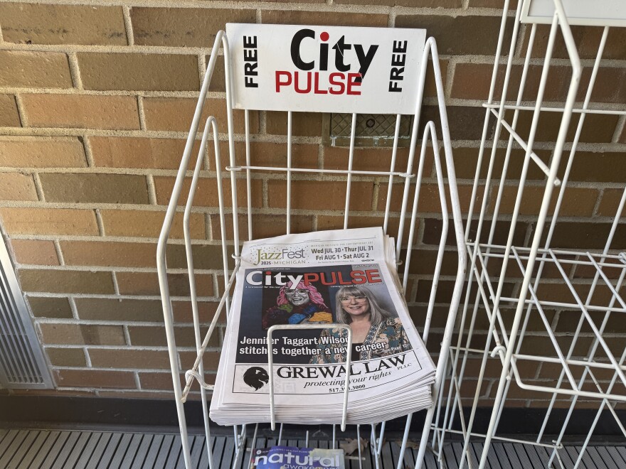 City Pulse newsstand with stacked copies
