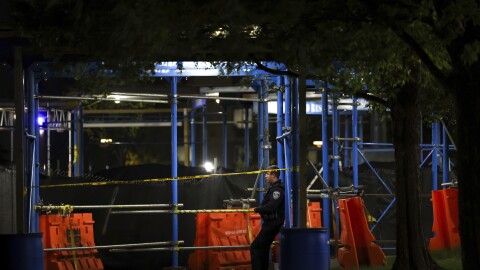 A police officer guards a crime scene area at Morgan State University after a shooting, Wednesday, Oct. 4, 2023, in Baltimore. (AP Photo/Julia Nikhinson)