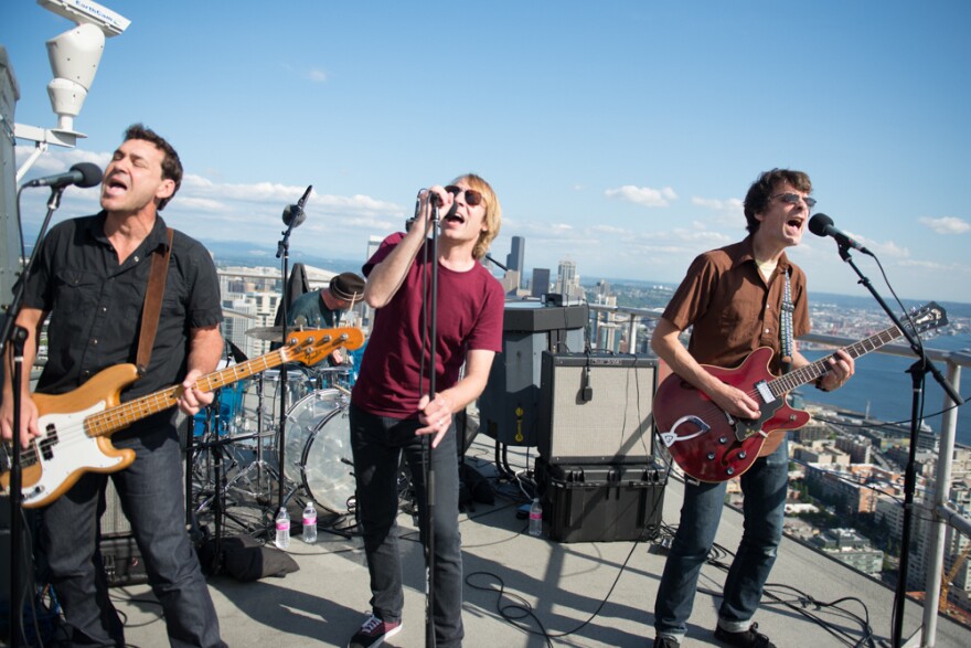 <strong>Touch Me I'm A Local Institution: </strong>Mudhoney plays from more than 500 feet above Seattle, on the roof of the Space Needle, as part of a set celebrating Sub Pop's Silver Jubilee broadcast by KEXP