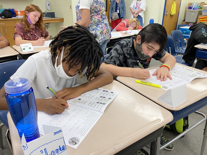 Children working at their school desks.