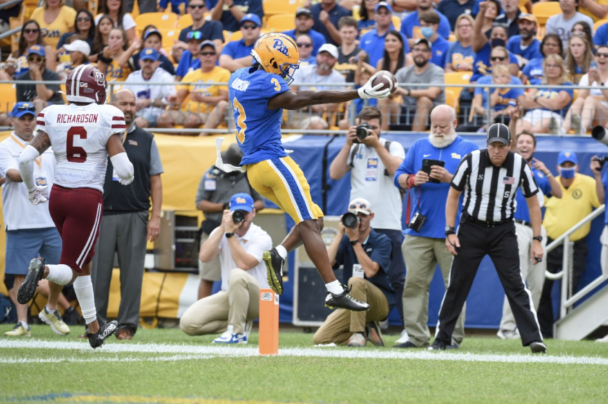 Jordan Addison (blue, 3) scores a touchdown in a game against UMass.