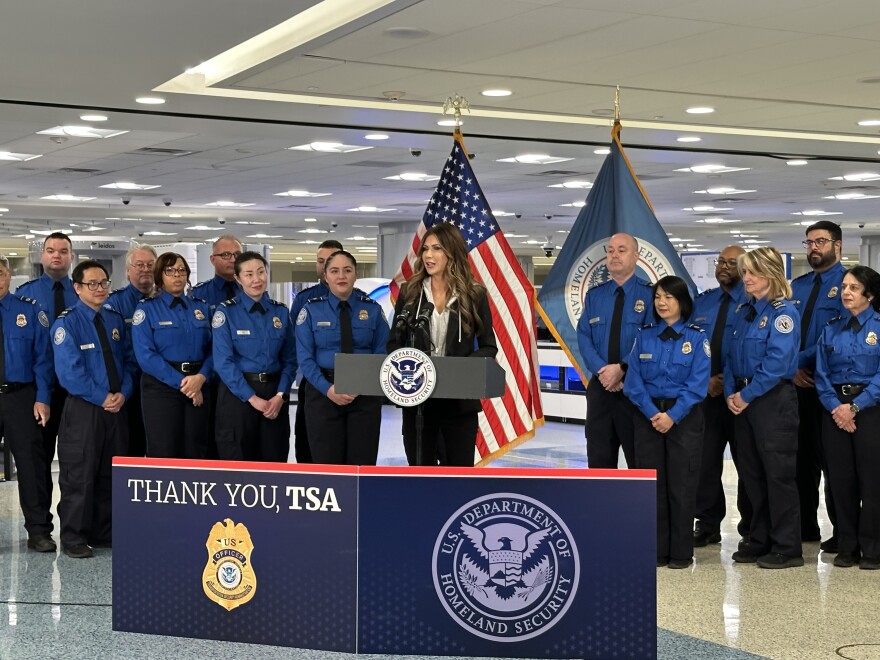 Dept. of Homeland Security Secretary Kristi Noem flanked by TSA employees at Harry Reid International Airport. Nov. 22, 2025