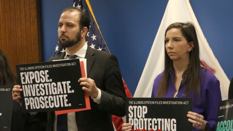 Rep. Abdelnasser Rashid and Rep. Anne Stava hold signs promoting the Illinois Epstein Files Investigation Act at a news conference in downtown Chicago on March 2, 2026.