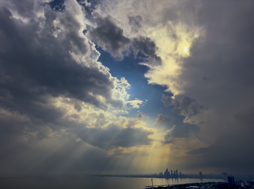 Sun rays break through the clouds above Toronto in June 2024. Toronto is one of the Great Lakes cities that does not shut off water for late payment.