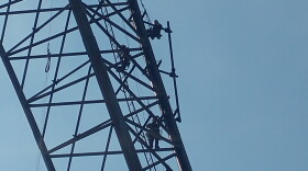 Workers preparing to install temporary WVXU and WGUC broadcast equipment on the Star 64 Tower on Winton Road.