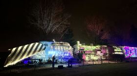 An old train is decorated in Christmas lights