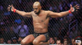 FILE -Jon Jones goes through his pre-fight routine in the ring before a light heavyweight mixed martial arts bout against Dominick Reyes at UFC 247, Saturday, Feb. 8, 2020, in Houston. Jones hired a team to help him get ready for Saturday, March 4, 2023, when he will take a step up to the heavyweight division and end any doubt — if any remain — that he is the greatest fighter in UFC history. (AP Photo/Michael Wyke)