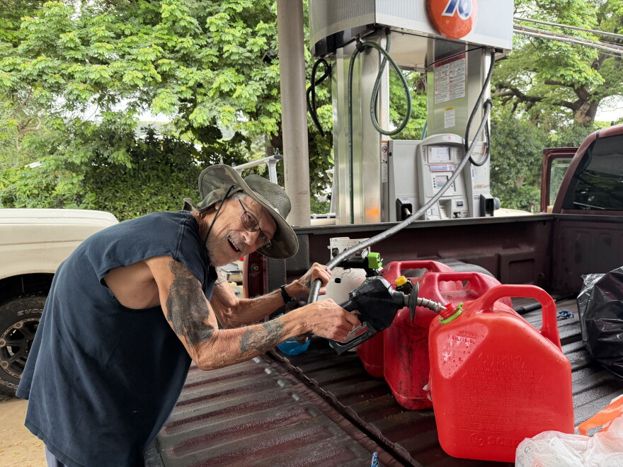 Nāʻālehu resident Joe Steele fills up gas cans at the townʻs gas station on the afternoon of Friday, Sept. 25, 2026, in preparation for Hurricane Nolo.