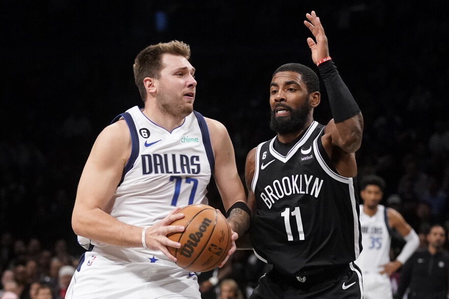 Dallas Mavericks guard Luka Doncic (77) drives against Brooklyn Nets guard Kyrie Irving (11) during the first half of an NBA basketball game, Thursday, Oct. 27, 2022, in New York. 