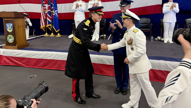 British Gen. Nick Perry shakes hands with U.S. Vice Admiral Doug Perry during the change of command on USS Nimitz.