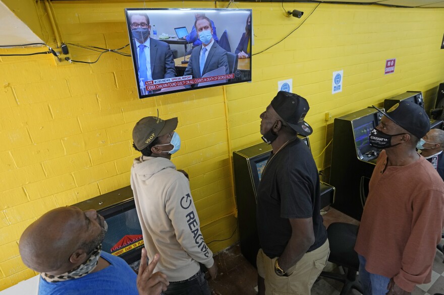 People gather inside a convenience store in the Houston neighborhood where George Floyd grew up, to listen to the verdict in the murder trial of Derek Chauvin.