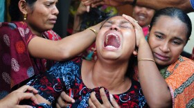 Relatives react after identifying the body of a loved one who was killed in last week's building collapse in Savar, on the outskirts of Dhaka, Bangladesh.