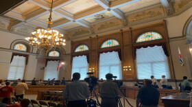 People stand for the Pledge of Allegiance at City Hall.