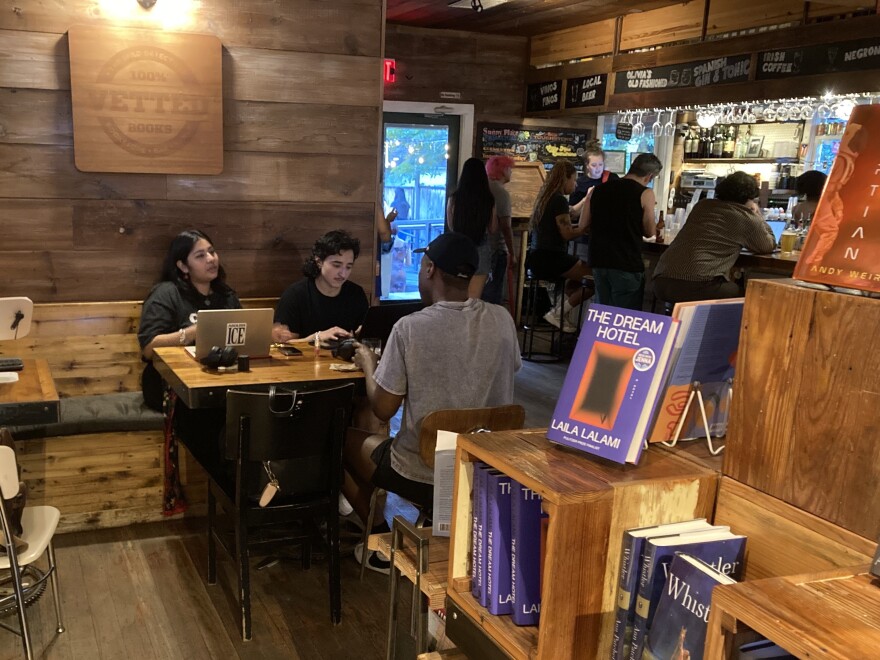 The Wild Detectives is a bookstore, bar and venue that hosts a variety of events, including live music, poetry readings, book clubs, workshops and salsa lessons. Lupe Aquilar (left) works on a proposal for her nonprofit with friends Addis Garza and Paul Johnson.