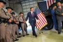 FILE - Florida Highway Patrol officers watch Gov. Ron DeSantis arrive at a press conference about a recent immigration enforcement operation, at the South Florida office of U.S. Immigration and Customs Enforcement and Enforcement and Removal Operations, May 1, 2025, in Miramar, Fla. 