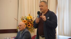 two men, one standing