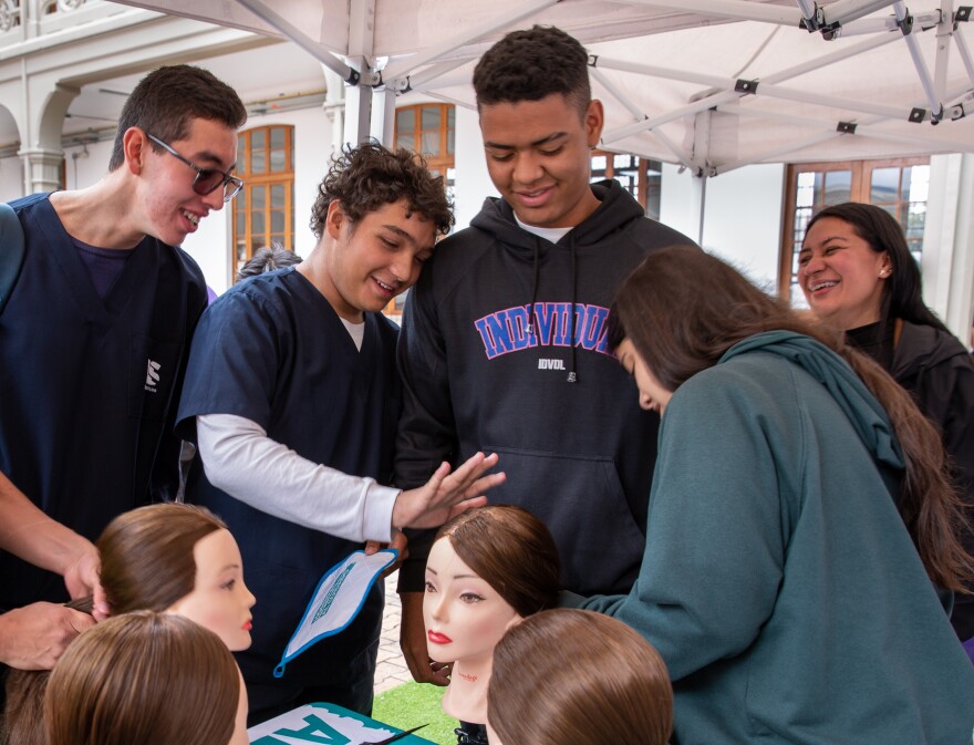 Mannequin heads offer a chance for men to practice hairstyling. Luis Rodríguez (second from left), a medical student, says the lesson made him appreciate his mom's workload at home. As for ponytails, he said he'd tried to do his sister's hair before, but this was the first time he felt confident about the result. "It looked really, really good, the way my mom does it," he says.