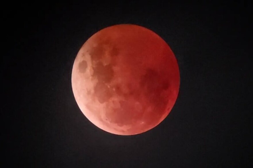 the moon with a reddish hue during a lunar eclipse