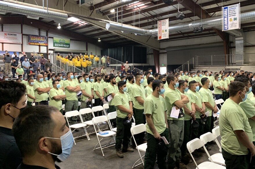 Fire crews and other audience members at a memorial for Frumencio Ruiz Carapia. Carapia's coworkers at Meford-based GE Forestry wore light green t-shirts.