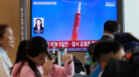 A TV screen shows a file image of a North Korean missile launch during a news program at Seoul Railway Station in Seoul, South Korea, Monday, Oct. 12, 2026.